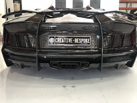 Rear diffuser detail of a black Lamborghini Aventador