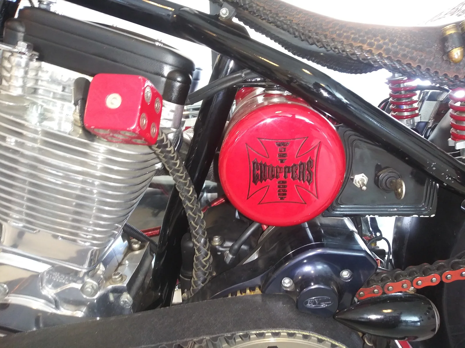 Close-up of a polished custom chopper engine and red accents