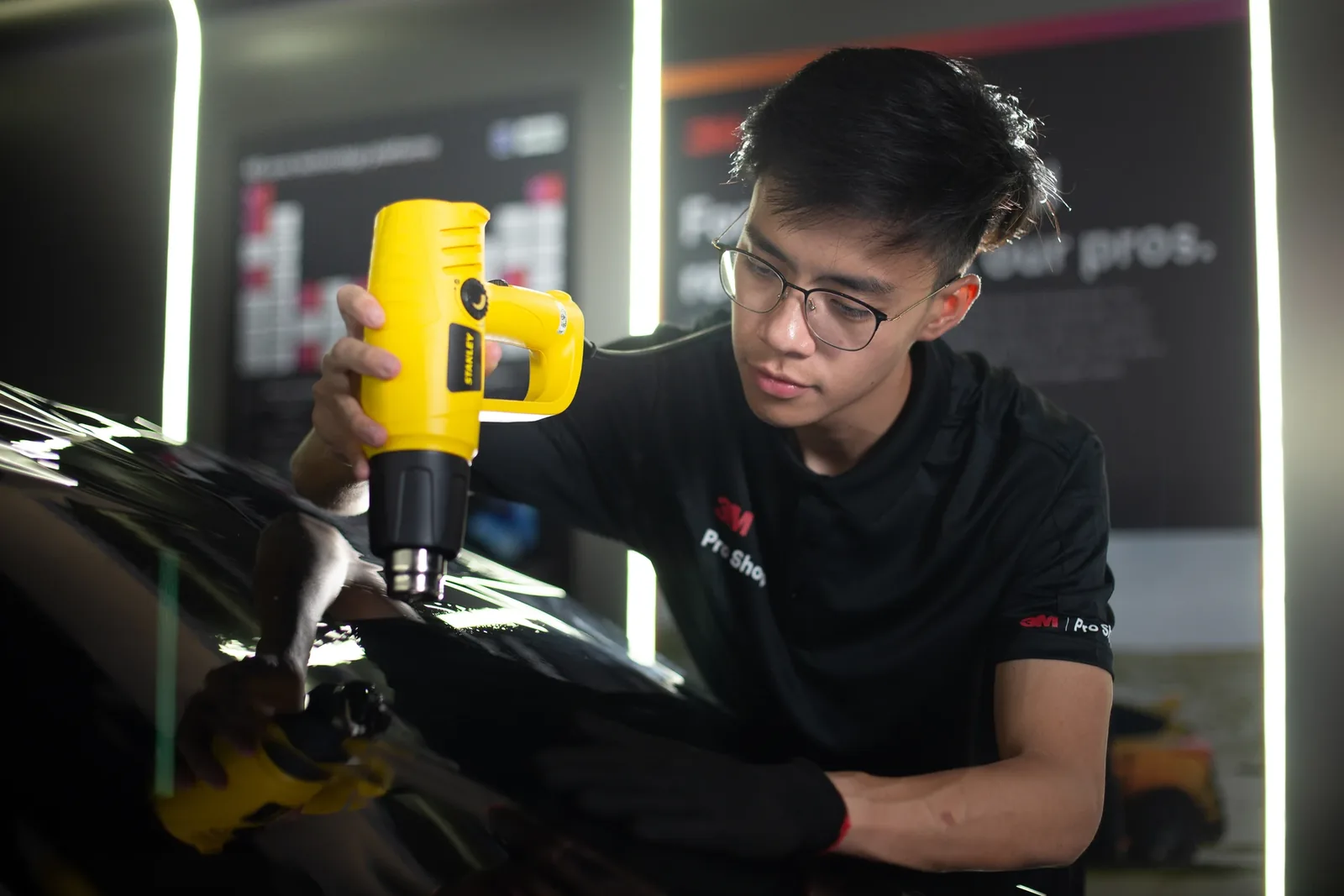 Close-up of paint correction polishing on glossy black paint