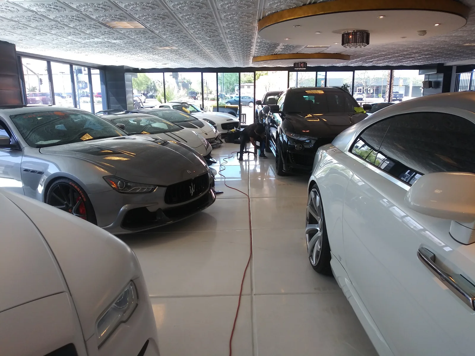 Row of luxury vehicles detailed inside the Scottsdale showroom