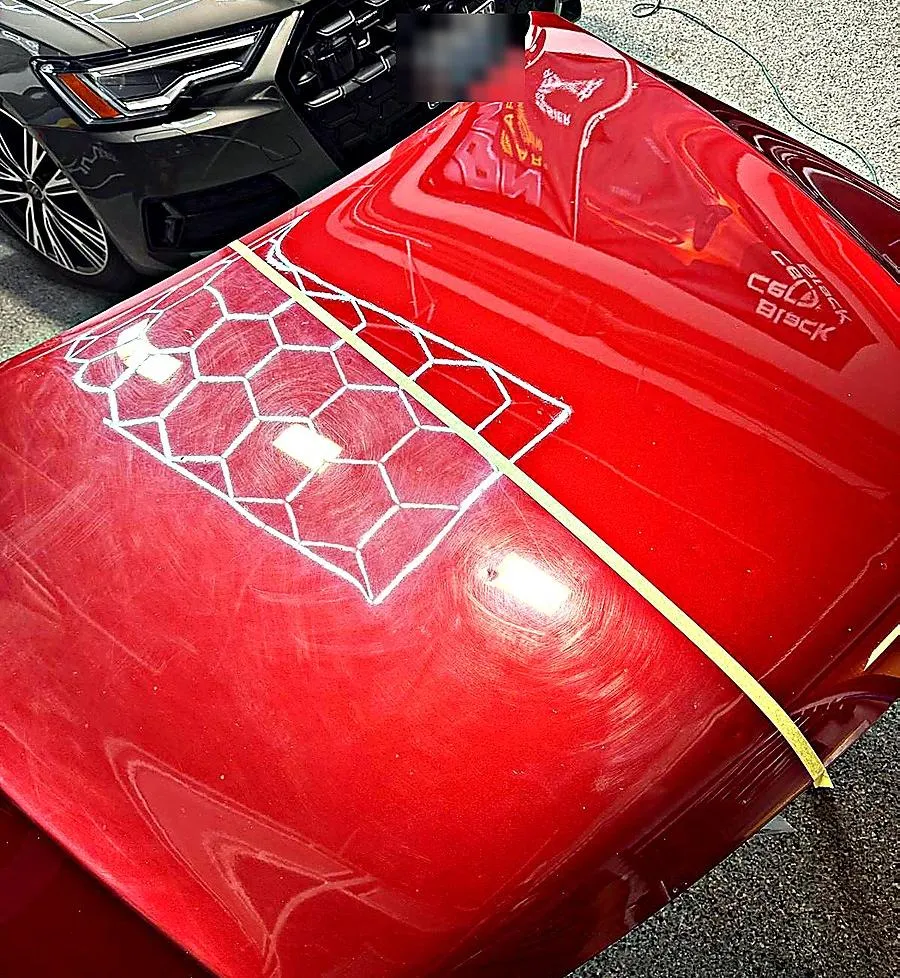 Red hood with repair pattern demonstrating renewable hybrid resin coating repair