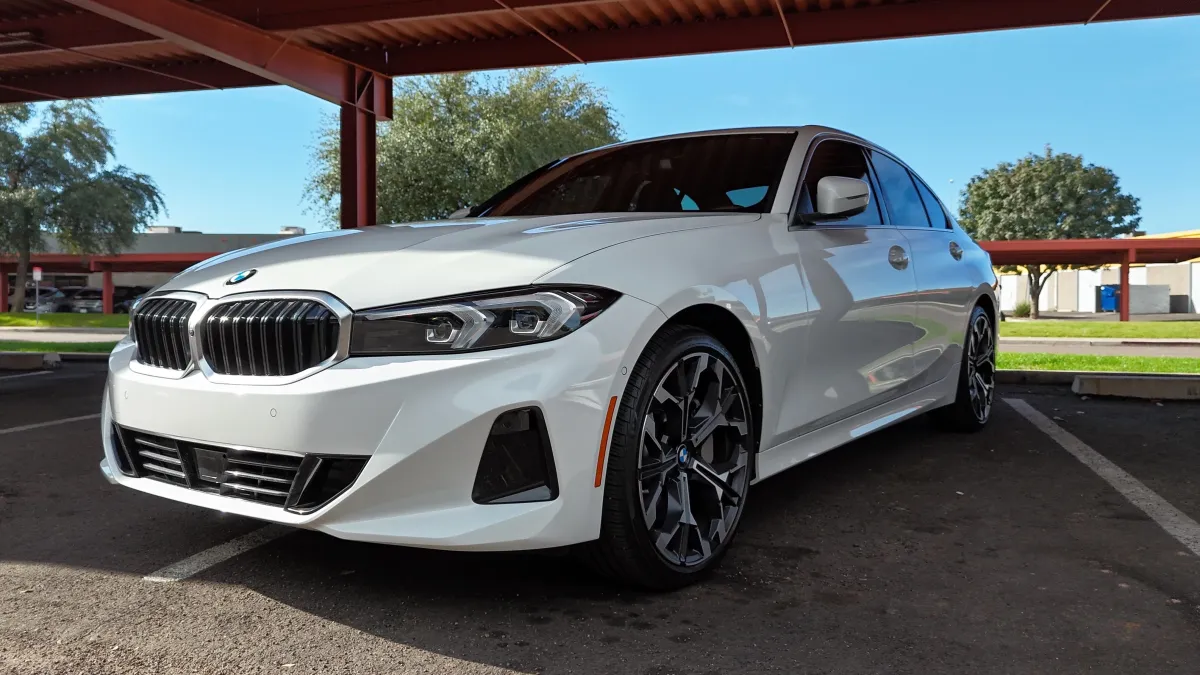 Technician applying AG Formula 1051 hybrid resin coating to a luxury vehicle in Scottsdale